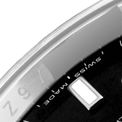 This close-up image shows a partial view of the dial and bezel of a Rolex Explorer 16570T Men's Stainless Steel Black Dial 16570T Men's Stainless Steel Black Dial watch, highlighting the "Swiss Made" text and part of an hour marker.