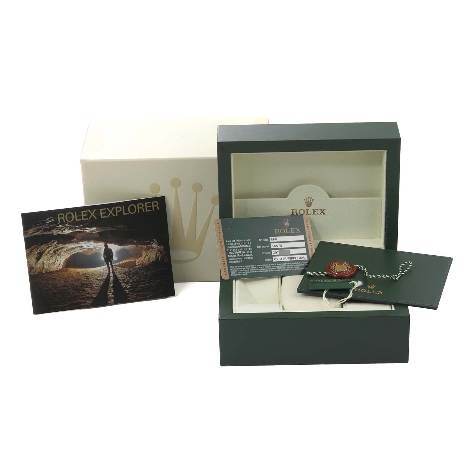 This image shows the packaging, warranty card, booklet, and tags for a Rolex Explorer 16570T Men's Stainless Steel Black Dial 16570T Men's Stainless Steel Black Dial model watch.