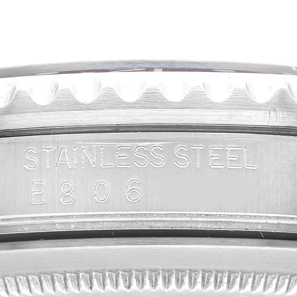 This image shows a close-up of the case side of the Rolex GMT-Master 16700 Men
s Stainless Steel Black Dial 16700 Men
s Stainless Steel Black Dial watch, highlighting its stainless steel marking and part of the bezel.