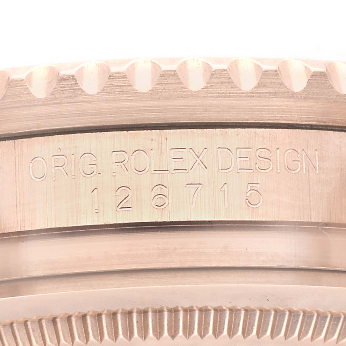 This image shows a close-up of the side of a Rolex GMT-Master 126715CHNR Men
s Rose Gold Black Dial 126715CHNR Men
s Rose Gold Black Dial model, detailing the engraved Rolex design number "126715".