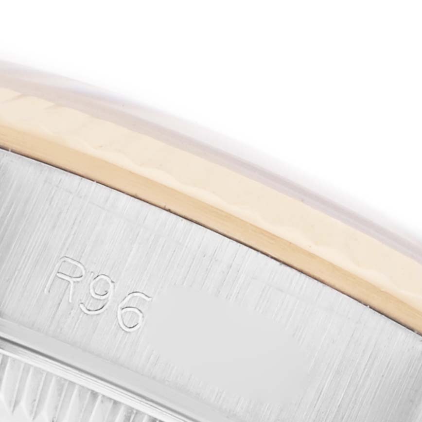 The image shows a close-up of the side of the Rolex Oyster Perpetual 67193 Women's Steel and Gold (two tone) Champagne Dial 67193 Women's Steel and Gold (two tone) Champagne Dial, highlighting the bezel and engraved details.