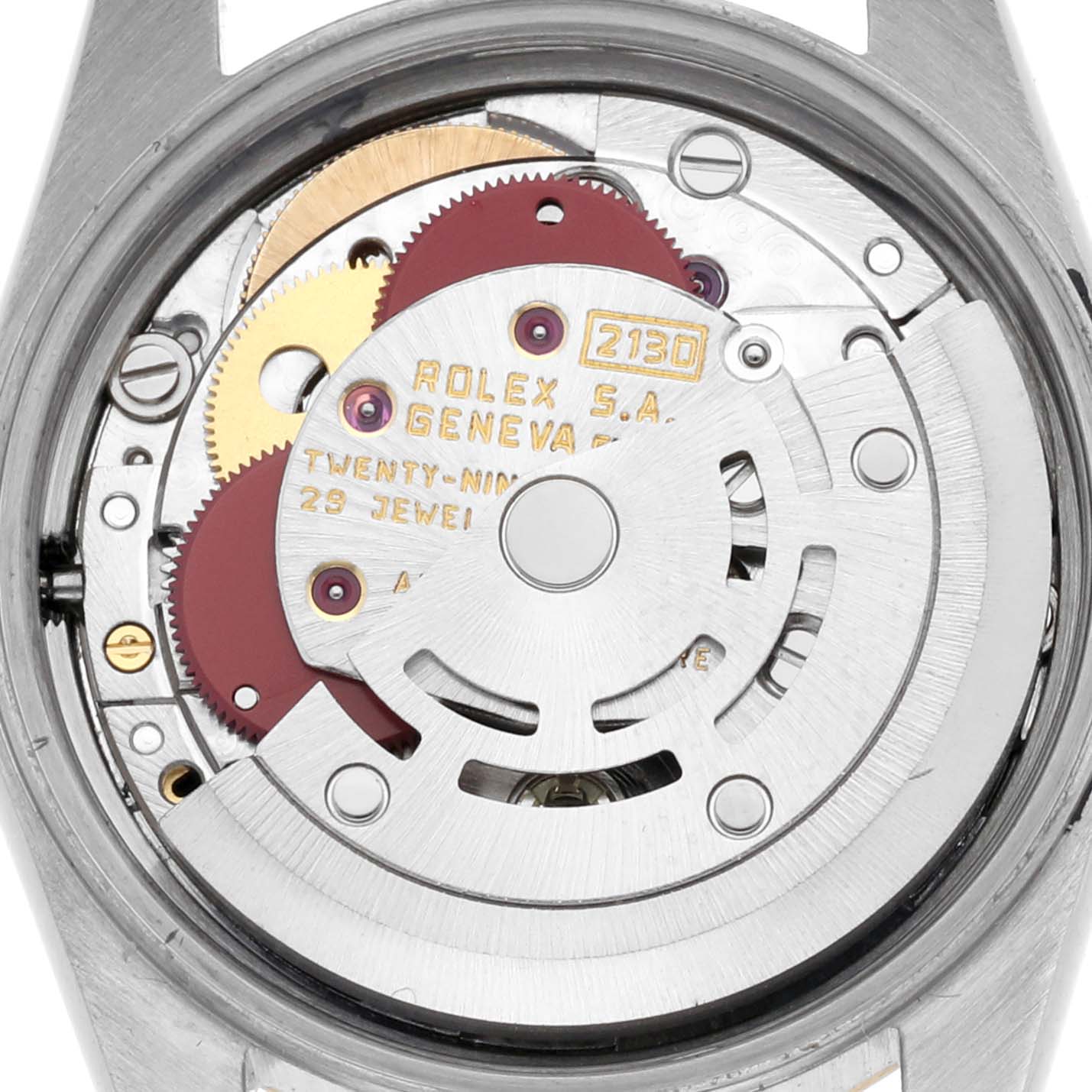 The image shows the movement of a Rolex Oyster Perpetual 67193 Women's Steel and Gold (two tone) Champagne Dial 67193 Women's Steel and Gold (two tone) Champagne Dial watch from a rear angle, highlighting gears and mechanisms.