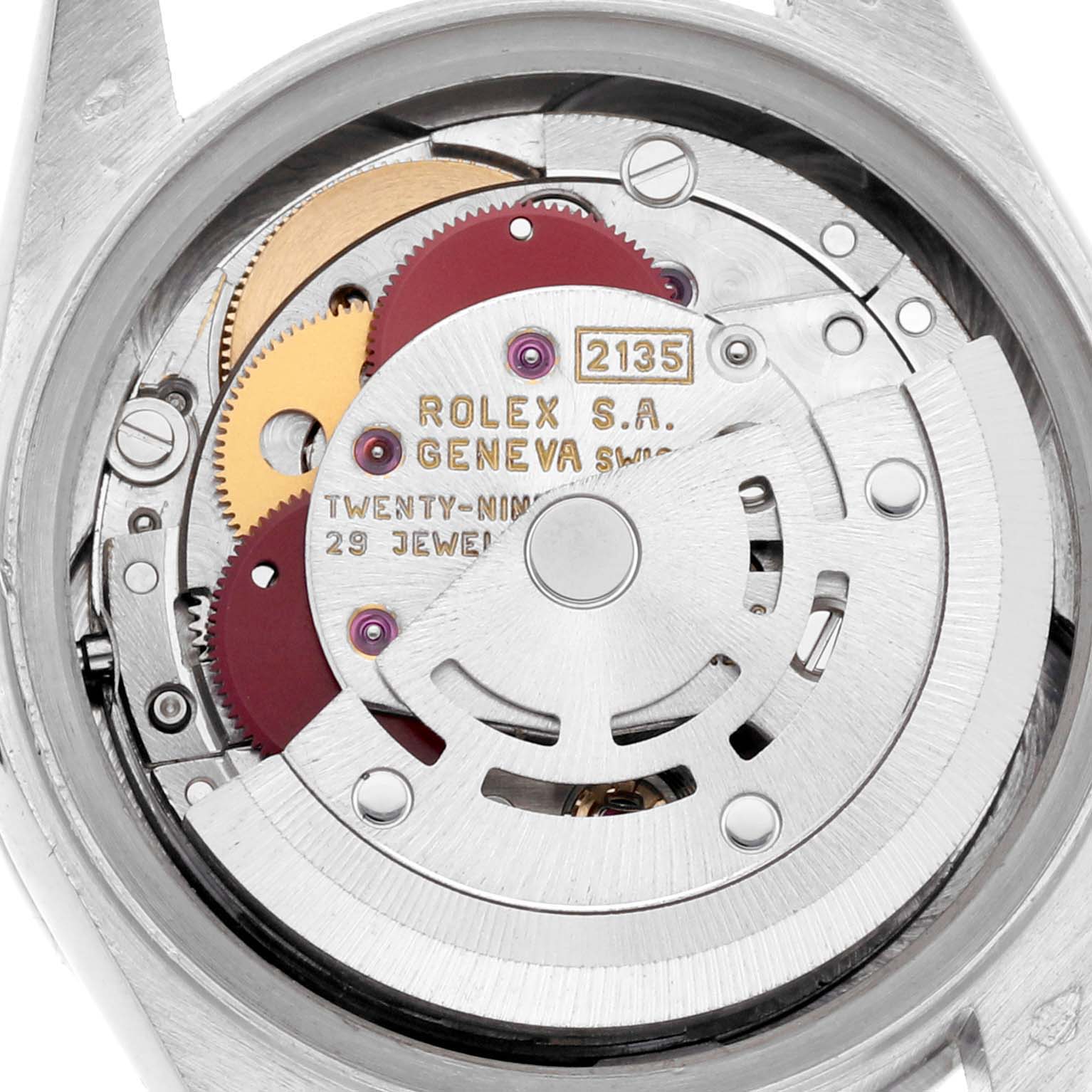 The image shows the movement mechanism of a Rolex President 69136 Women's Platinum Silver Dial 69136 Women's Platinum Silver Dial watch viewed from the back, highlighting gears and text details.