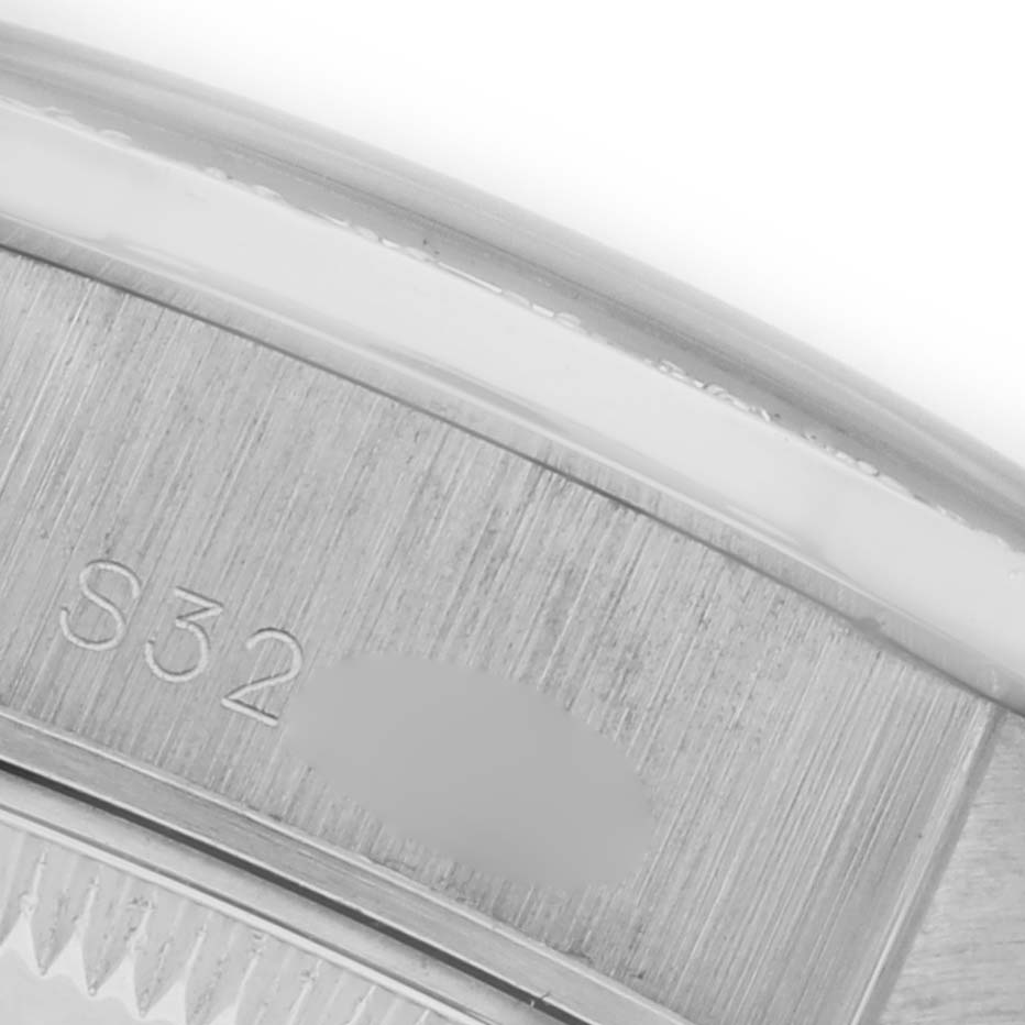 This image shows a close-up of the engraved inner bezel of a Rolex President 69136 Women's Platinum Silver Dial 69136 Women's Platinum Silver Dial watch.