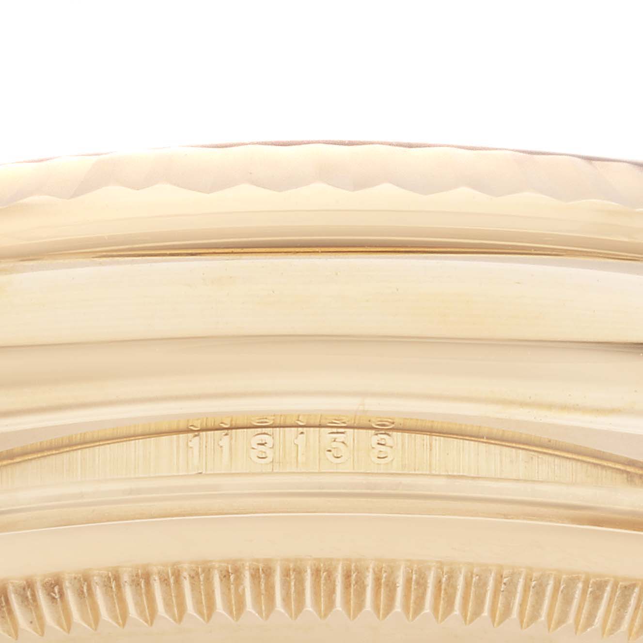 The image shows a close-up of the bezel and part of the case of the Rolex President 118138 Men's Yellow Gold Green Dial 118138 Men's Yellow Gold Green Dial model watch.