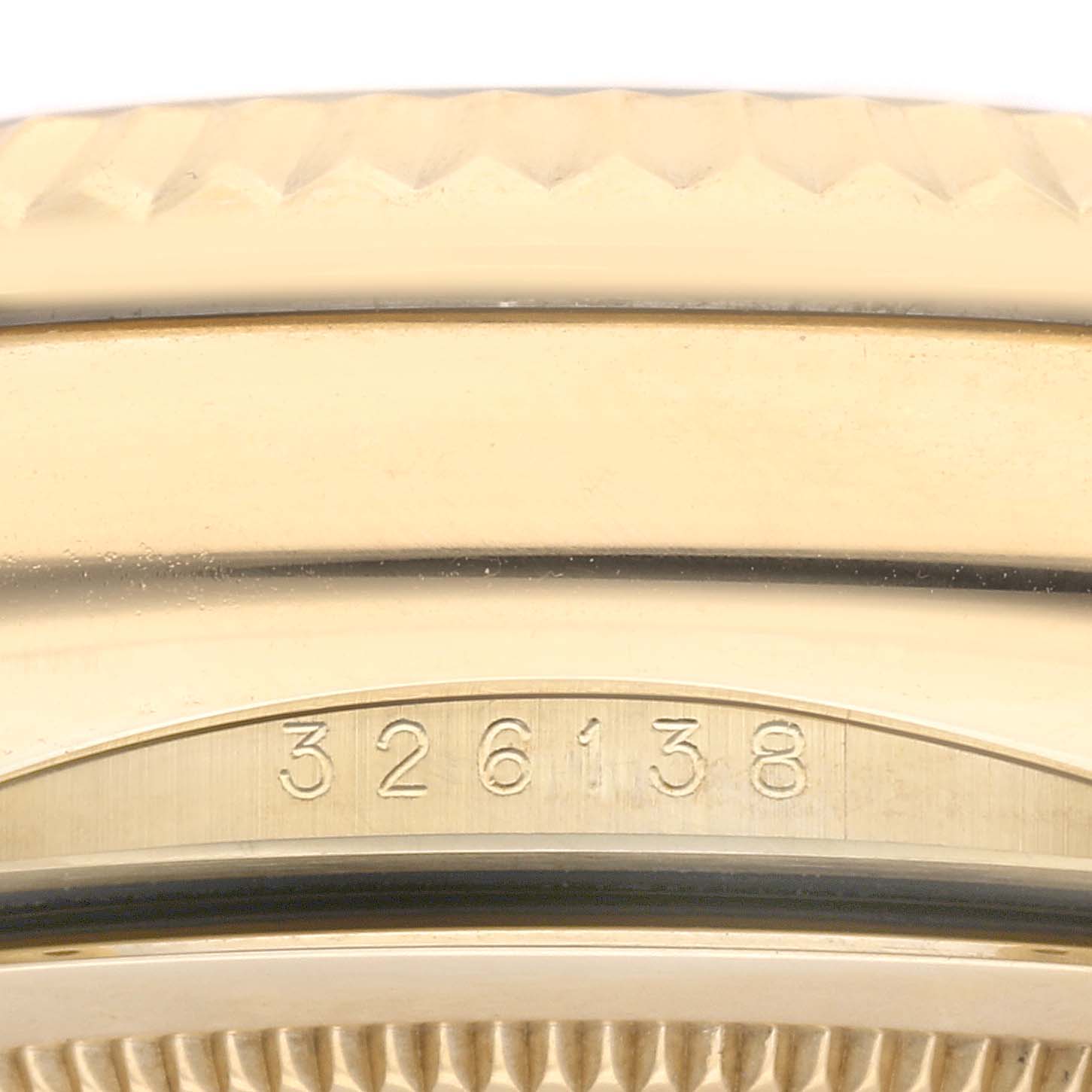 This image shows a close-up angle of the bezel and case edge of a Rolex Sky-Dweller 326138 Men's Yellow Gold Silver Dial 326138 Men's Yellow Gold Silver Dial watch, with a partial view of its fluted design and model number 326138.