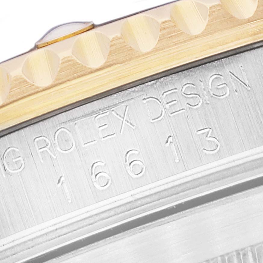 This image shows a close-up of the bezel and engravings on the side of a Rolex Submariner 16613 Men's Steel and Gold (two tone) Blue Dial 16613 Men's Steel and Gold (two tone) Blue Dial watch.