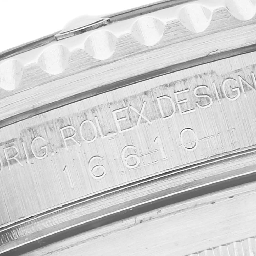 This image shows a close-up of the engraved serial number and design details on the side of a Rolex Submariner 16610 Men
s Stainless Steel Black Dial 16610 Men
s Stainless Steel Black Dial watch bezel.