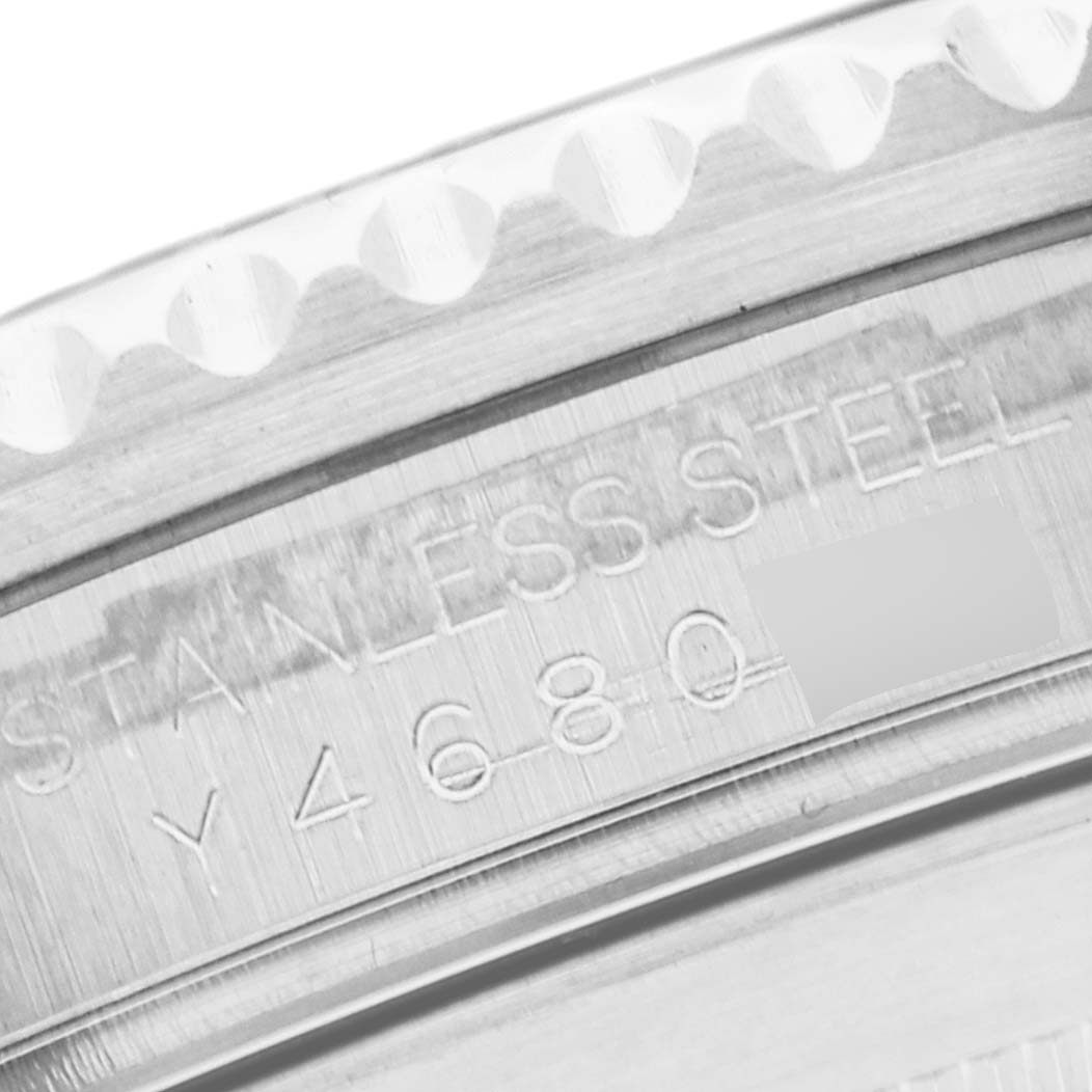 The image shows a close-up view of the stainless steel bezel and part of the case back of a Rolex Submariner 16610 Men
s Stainless Steel Black Dial 16610 Men
s Stainless Steel Black Dial watch.