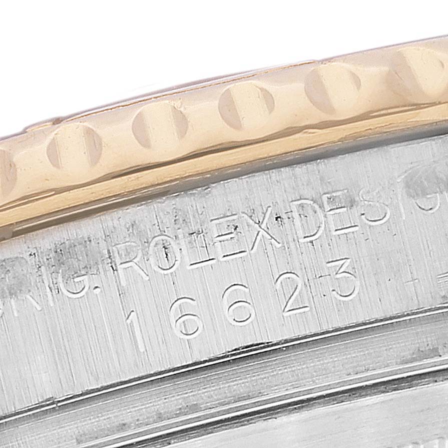 The image shows a close-up angle of the Rolex Yacht-Master 16623 Men
s Steel and Gold (two tone) White Dial 16623 Men
s Steel and Gold (two tone) White Dial model bezel and part of the case with engraved model details.