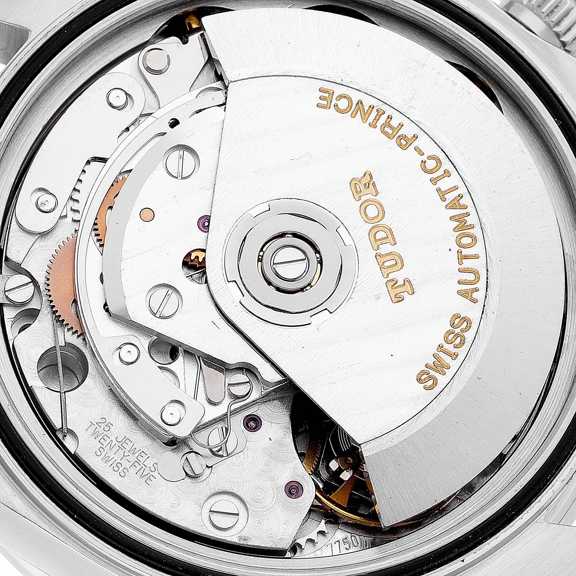 The image shows the intricate mechanical movement of a Tudor Tiger 79280 Men's Stainless Steel Blue Dial 79280 Men's Stainless Steel Blue Dial model watch with branding and technical details visible.