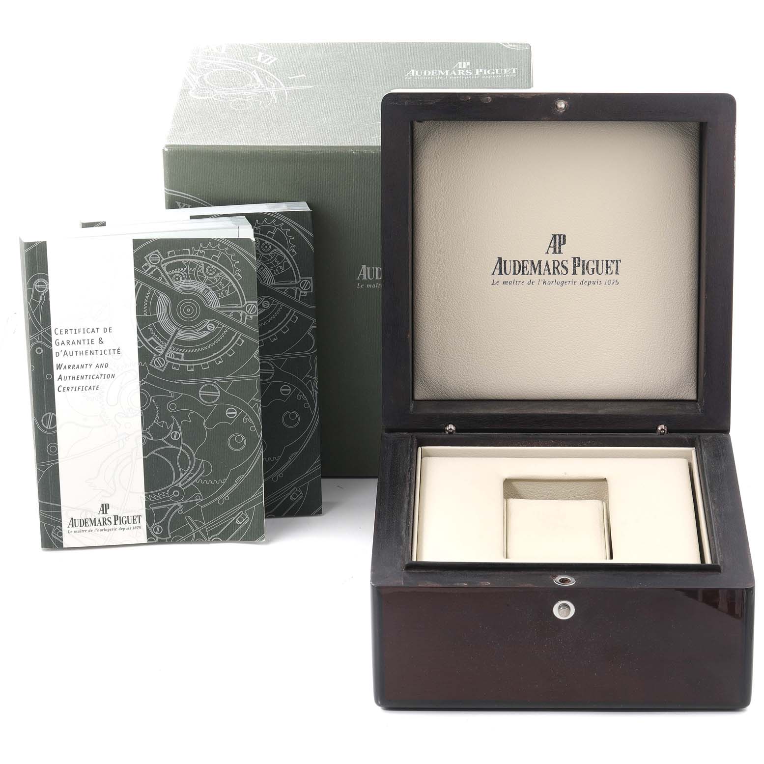 The image shows an open Royal Oak box by Audemars Piguet, alongside warranty and authentication certificates.