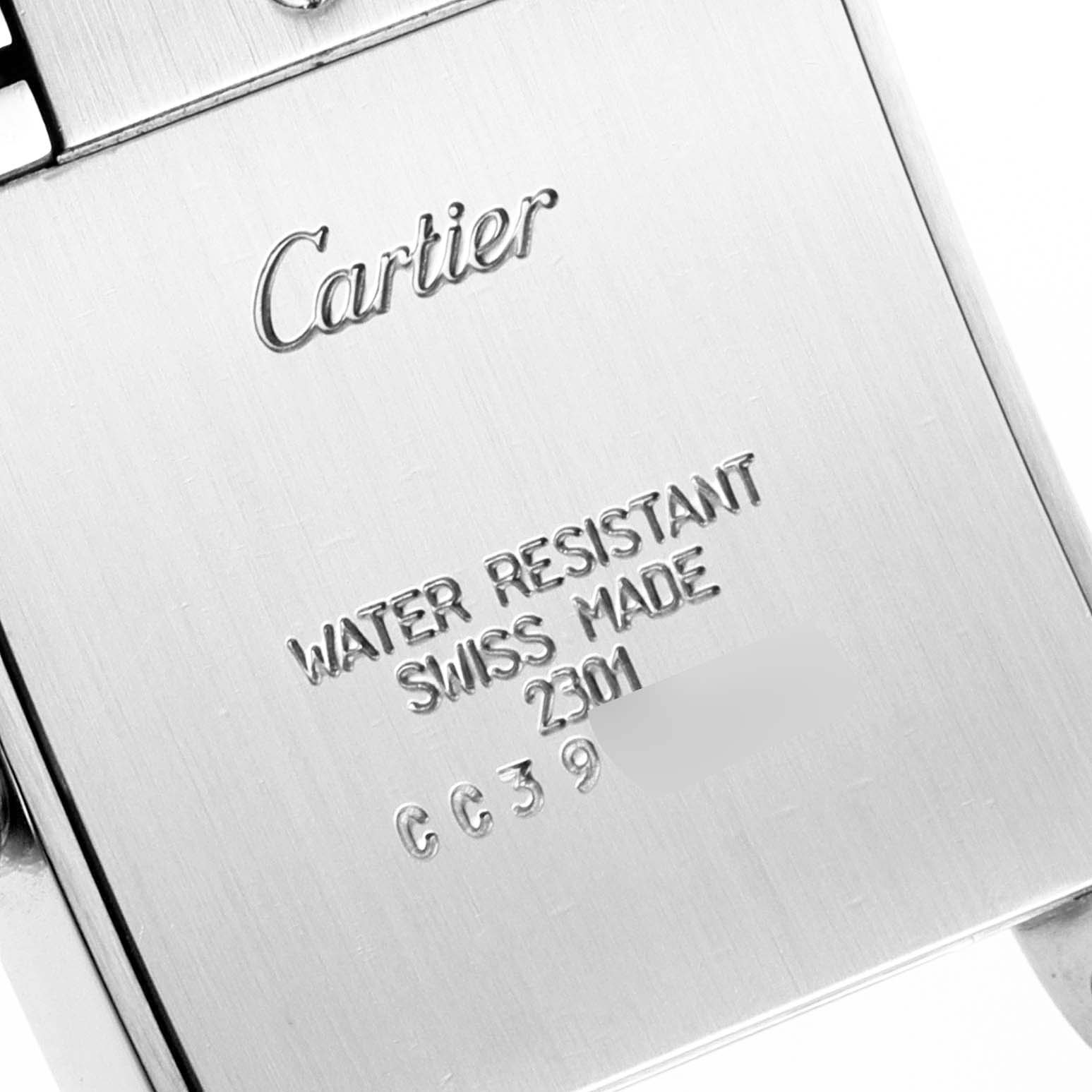 This close-up image shows the back of a Cartier Tank Française watch with engraved brand and specifications.