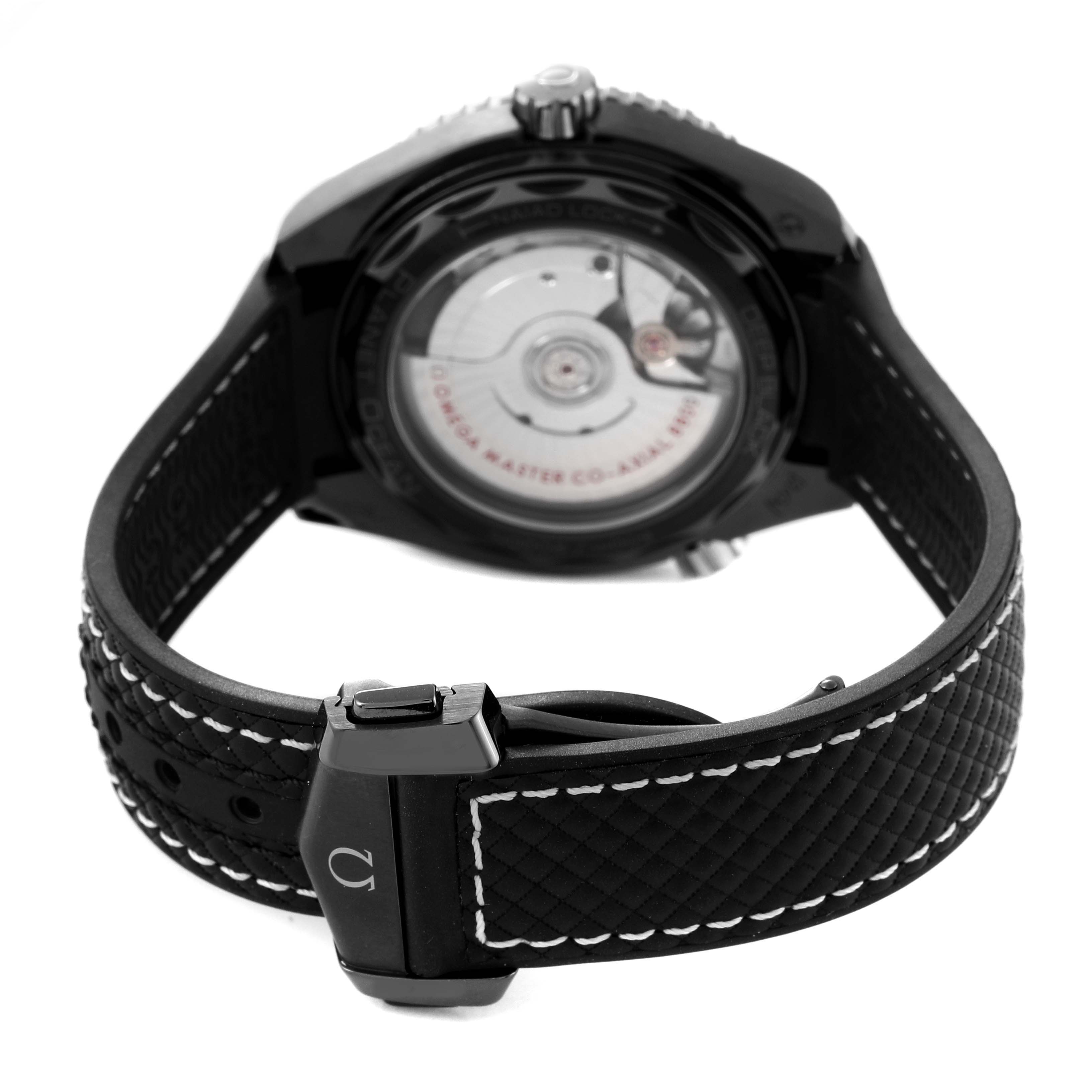 The image shows the back case and strap of an Omega Planet Ocean 215.92.40.20.01.001 Men's Ceramic Black Dial 215.92.40.20.01.001 Men's Ceramic Black Dial watch, featuring its inner mechanism and clasp.