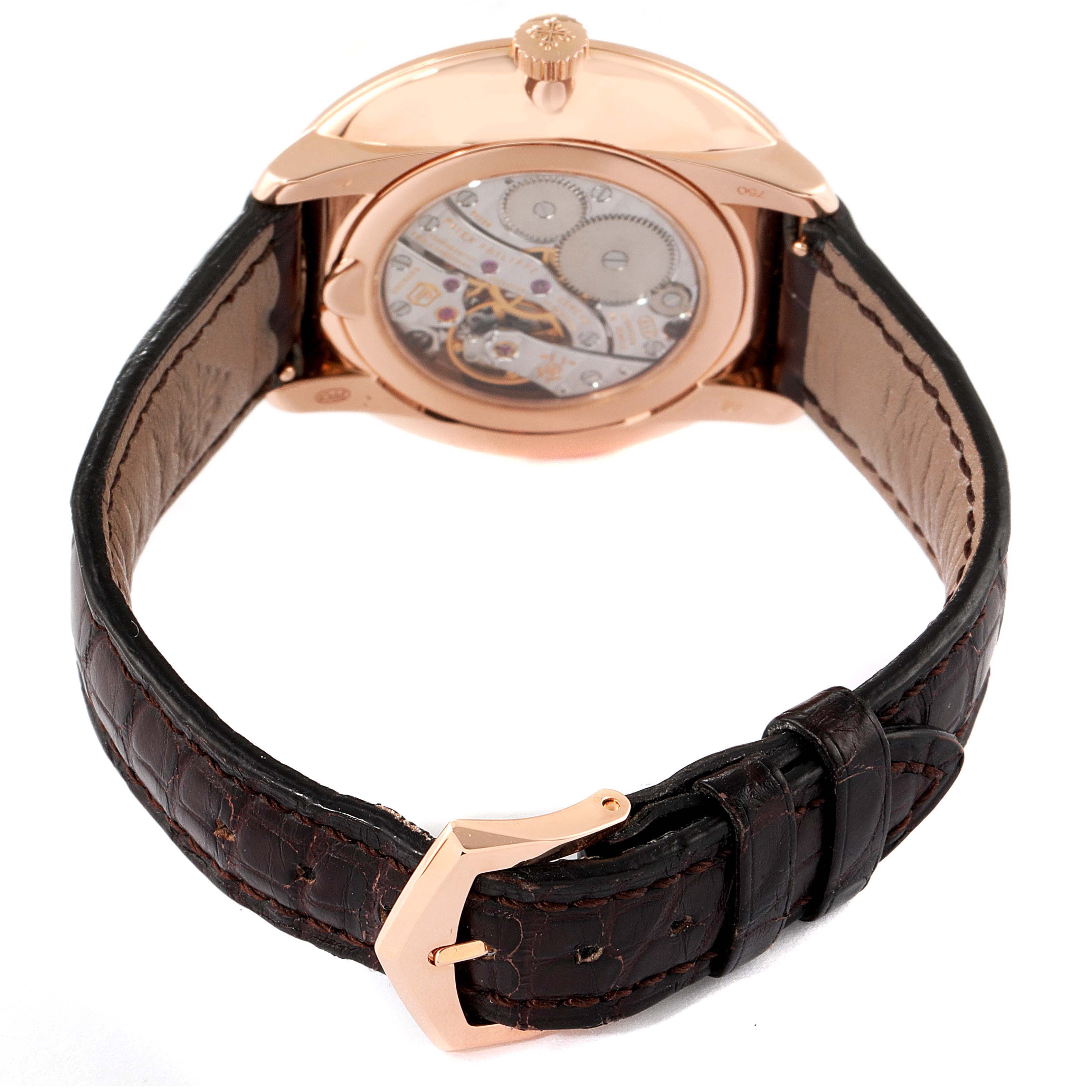 The image shows the back view of a Patek Philippe Calatrava 5123R-001 Men's Rose Gold Silver Dial 5123R-001 Men's Rose Gold Silver Dial watch with its open case back and leather strap.