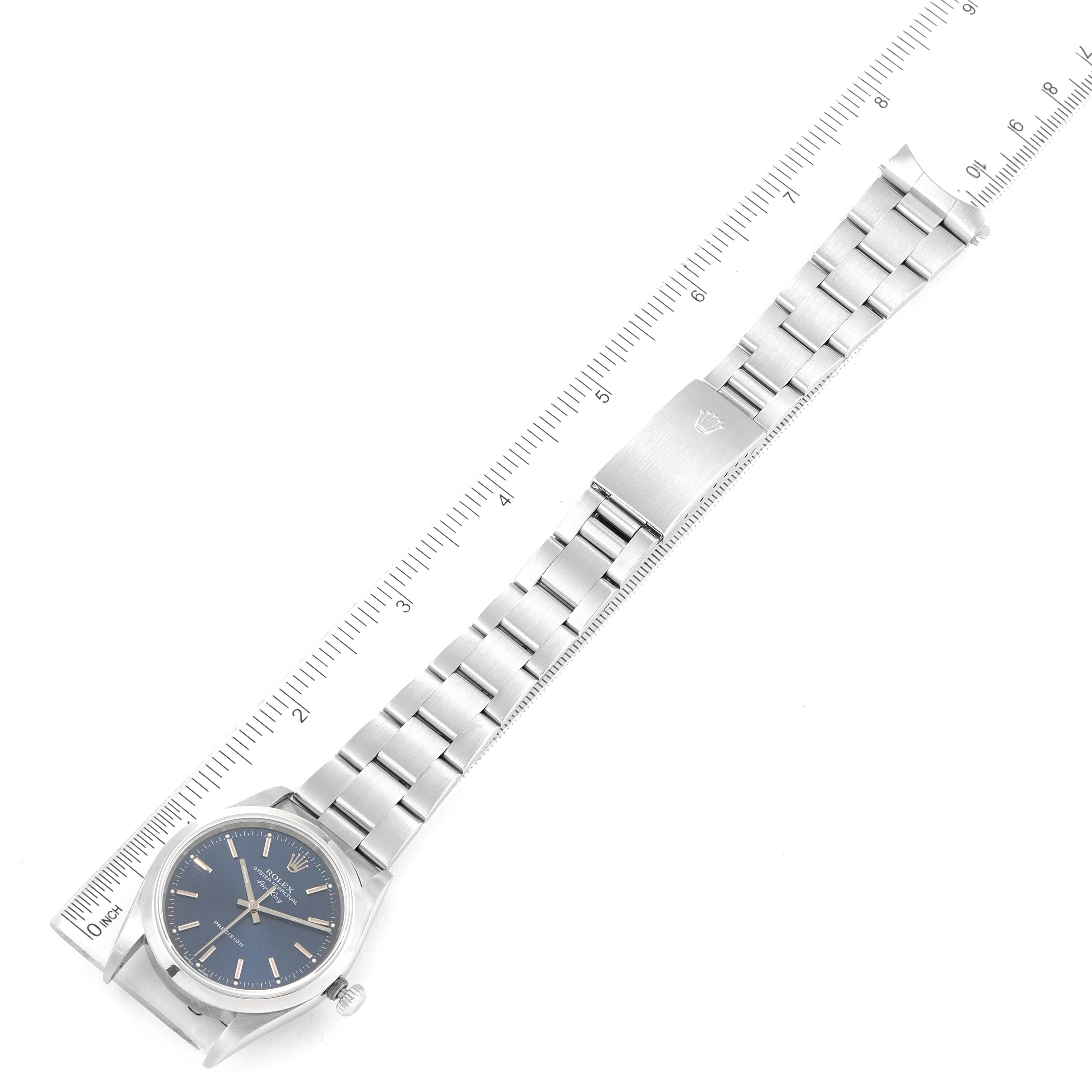 The image shows the full length of a Rolex Air-King 14000 Men's Stainless Steel Blue Dial 14000 Men's Stainless Steel Blue Dial watch laid flat next to a ruler, highlighting the face, bracelet, and clasp.