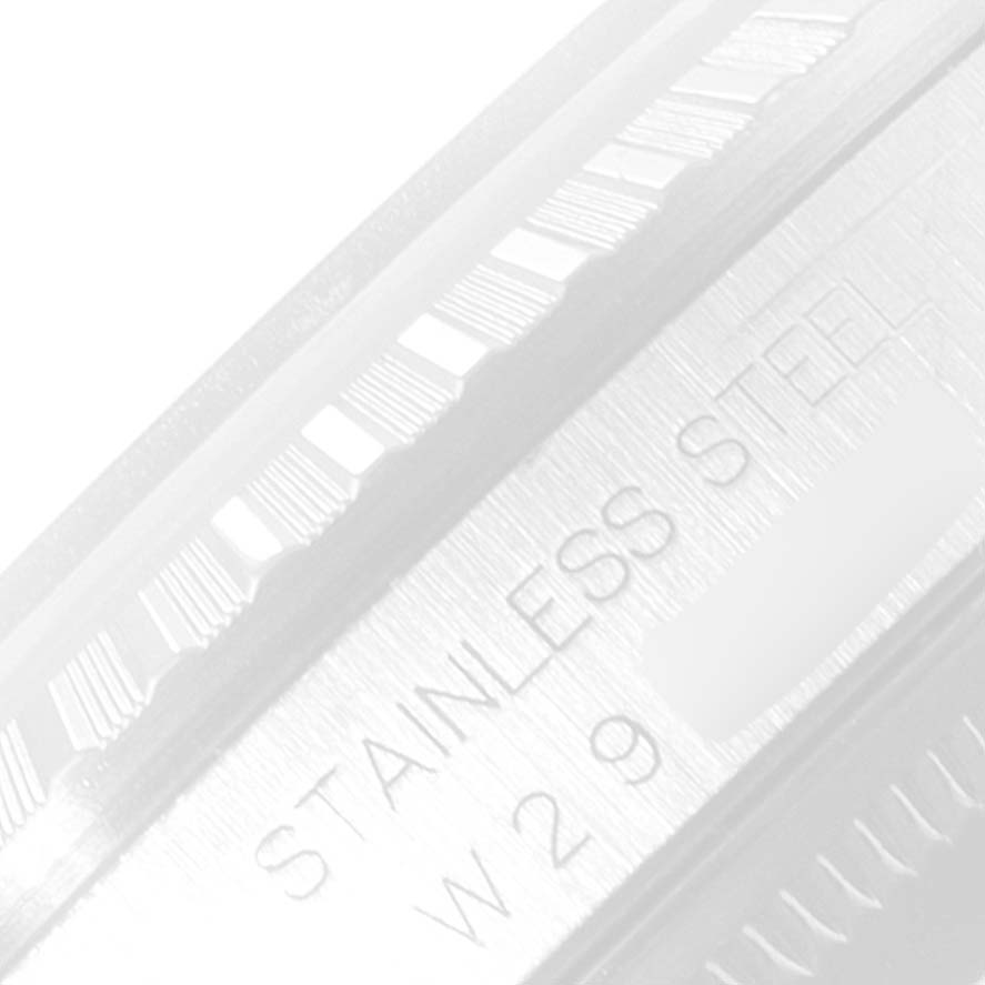 This image shows a close-up of the side of the bezel with engravings on a Rolex Datejust 16220 Men's Stainless Steel Blue Dial 16220 Men's Stainless Steel Blue Dial watch.