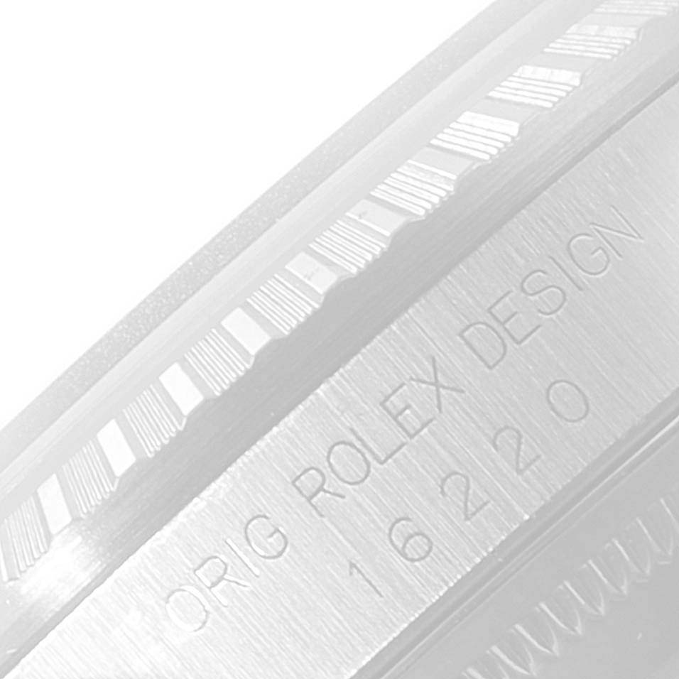 The image shows a close-up of a bezel and engraved text on a Rolex Datejust 16220 Men's Stainless Steel Blue Dial 16220 Men's Stainless Steel Blue Dial watch.