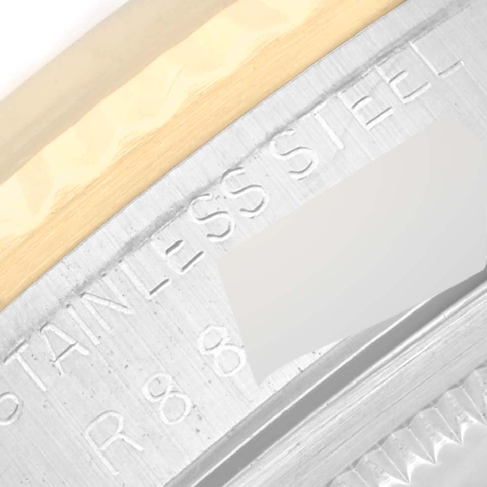 This is a close-up of the Rolex Datejust 16233 Men's Steel and Gold (two tone) Black Dial 16233 Men's Steel and Gold (two tone) Black Dial watch, focusing on the stainless steel and gold on its bezel and case.