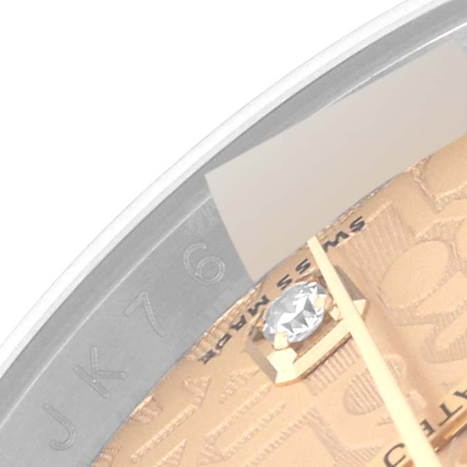 This image shows a close-up of the dial and part of the bezel of a Rolex Datejust 116243 Men's Steel and Gold (two tone) Champagne Dial 116243 Men's Steel and Gold (two tone) Champagne Dial watch.