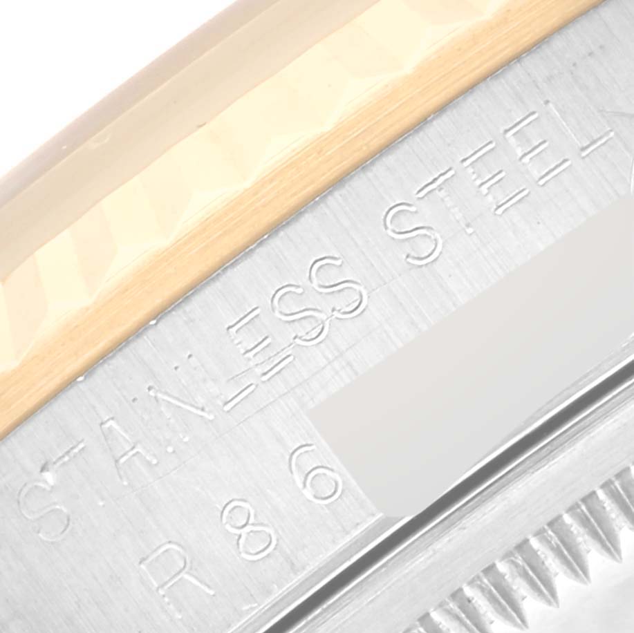 The image shows a close-up of the bezel and engraved "STAINLESS STEEL" text on a Rolex Datejust 16233 Men's Steel and Gold (two tone) Blue Dial 16233 Men's Steel and Gold (two tone) Blue Dial watch.