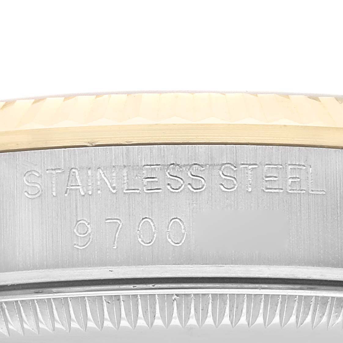 This image shows a close-up of the stainless steel case and part of the bezel of a mid-size Rolex watch model.