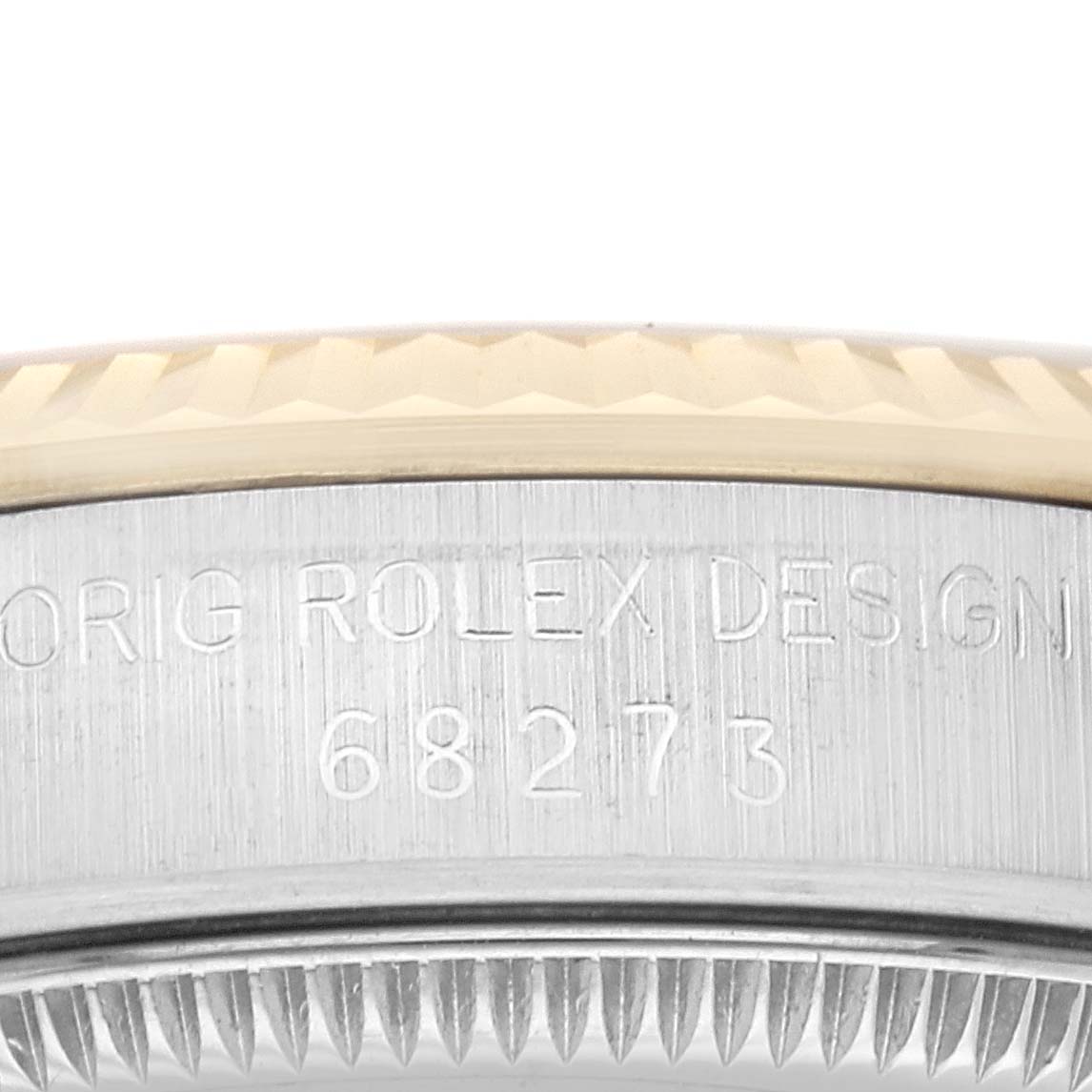 This close-up image shows the side case with the model number and part of the bezel of a Mid-Size Rolex watch.