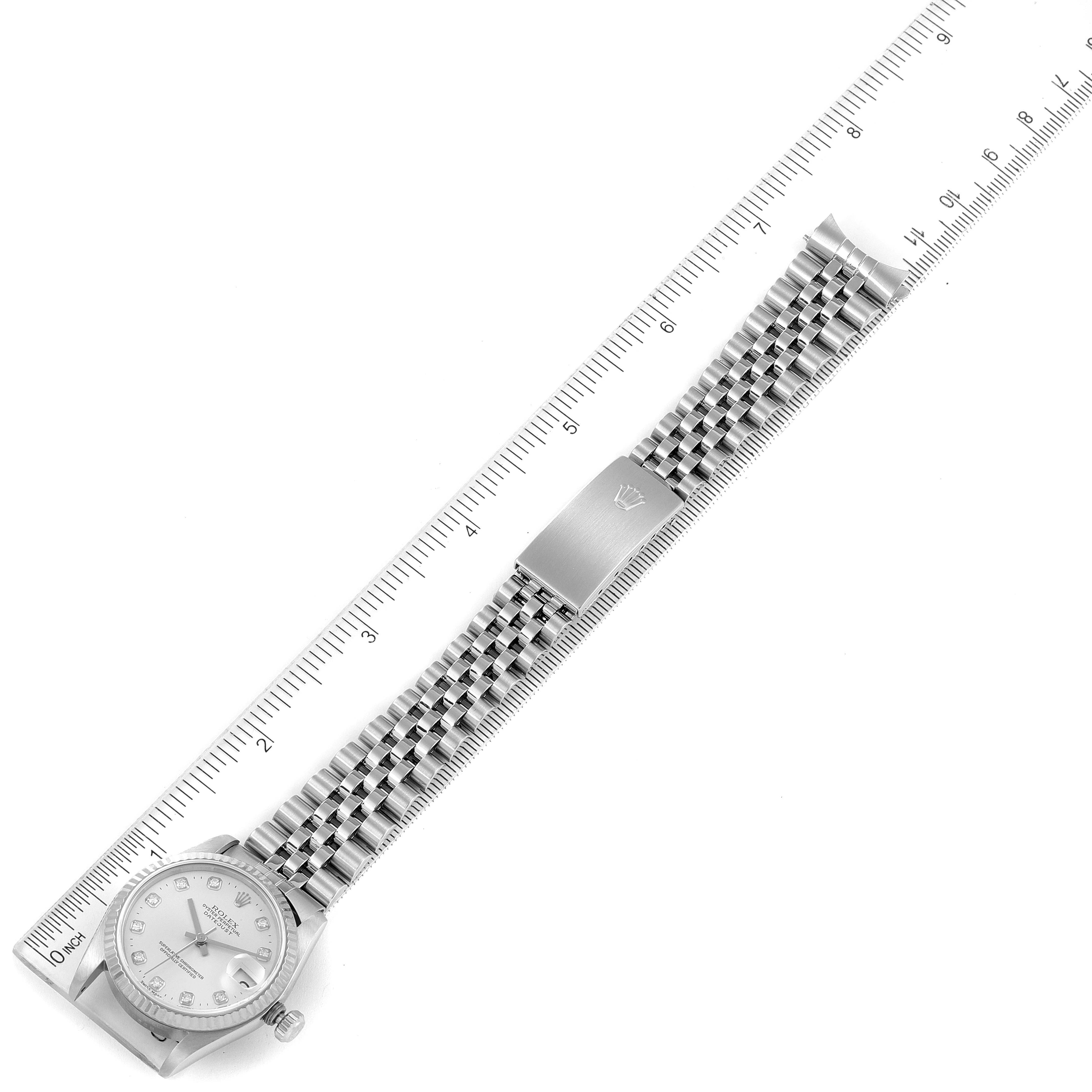 The image shows a Rolex Mid-Size 68274 Women's Stainless Steel Silver Dial 68274 Women's Stainless Steel Silver Dial model watch laid flat next to a ruler for scale.