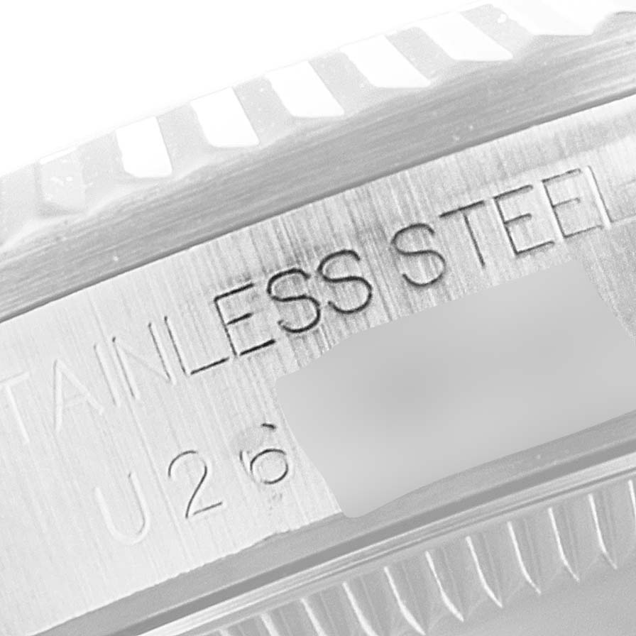 The image shows a close-up of the Rolex Mid-Size 68274 Women's Stainless Steel Silver Dial 68274 Women's Stainless Steel Silver Dial model's stainless steel case from the side angle, highlighting the bezel edge and engraved text.