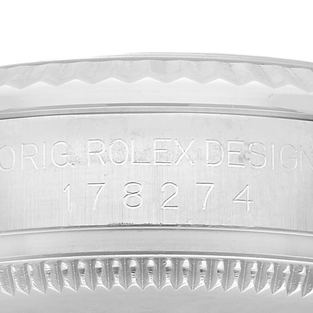 The image shows a close-up of the case side and engraved bezel of a Mid-Size Rolex watch.
