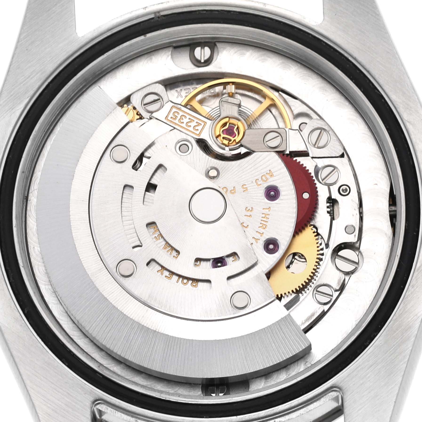 This image shows the internal mechanism of a Mid-Size Rolex watch, viewed from the back case.