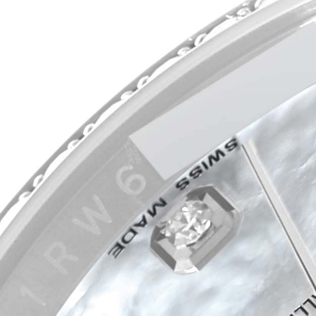 This is a close-up view of the Swiss Made text and diamond hour marker on the dial of a Rolex Datejust 116244 Men's Stainless Steel Mother of Pearl Dial 116244 Men's Stainless Steel Mother of Pearl Dial watch.