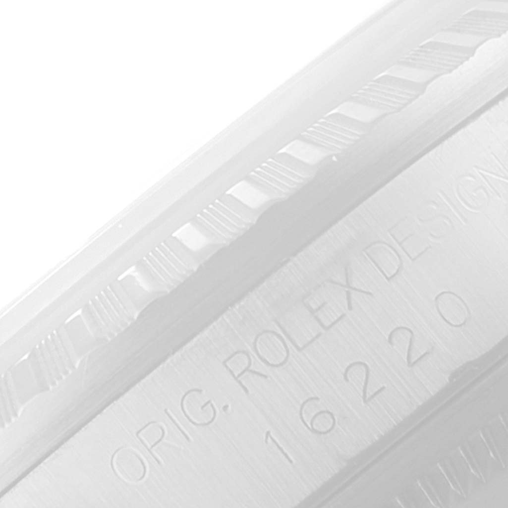 This image shows a close-up of the bezel and part of the case with engravings on a Rolex Datejust 16220 Men's Stainless Steel Silver Dial 16220 Men's Stainless Steel Silver Dial watch.