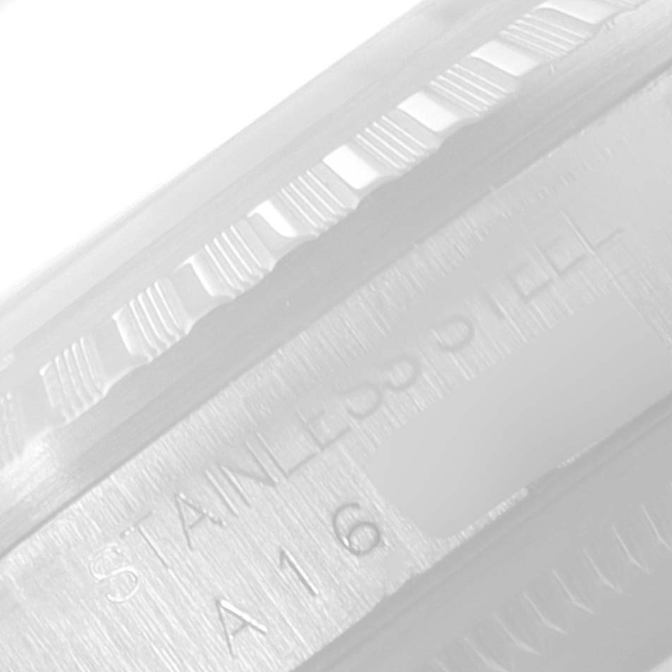 The image shows a close-up angle of the Rolex Datejust 16220 Men's Stainless Steel Silver Dial 16220 Men's Stainless Steel Silver Dial watch's fluted bezel with "STAINLESS STEEL" engraved on the case.