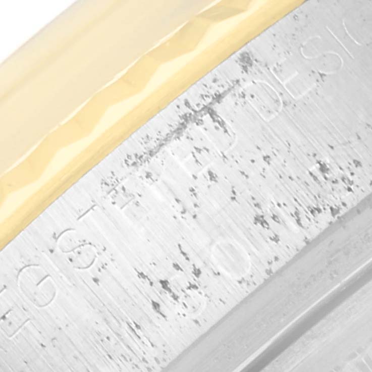 The image shows a close-up of the bezel and engraved text on the case side of a Vintage Collection Rolex watch.