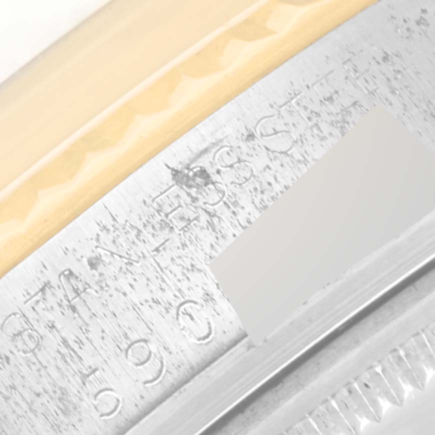 This image shows a close-up of the engraved serial number on the metal case of the Vintage Collection model by Rolex.