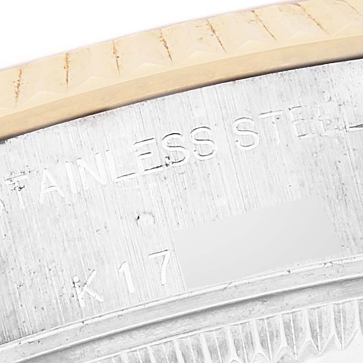 The image shows a close-up of the side engraving and part of the bezel of a Rolex Datejust 79173 Women's Steel and Gold (two tone) Mother of Pearl Dial 79173 Women's Steel and Gold (two tone) Mother of Pearl Dial watch.