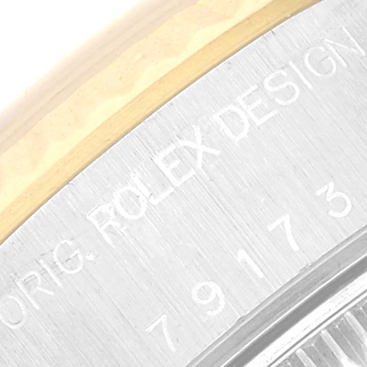 The image shows a close-up angle of the bezel and part of the case of a Rolex Datejust 79173 Women's Steel and Gold (two tone) Champagne Dial 79173 Women's Steel and Gold (two tone) Champagne Dial watch, highlighting "ROLEX DESIGN."