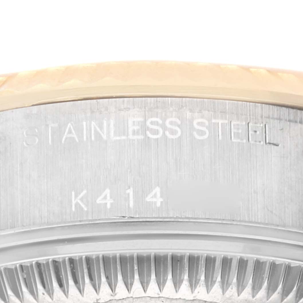 This close-up image shows part of the stainless steel case back and serial number engraving of a Rolex Datejust 79173 Women's Steel and Gold (two tone) Champagne Dial 79173 Women's Steel and Gold (two tone) Champagne Dial watch.