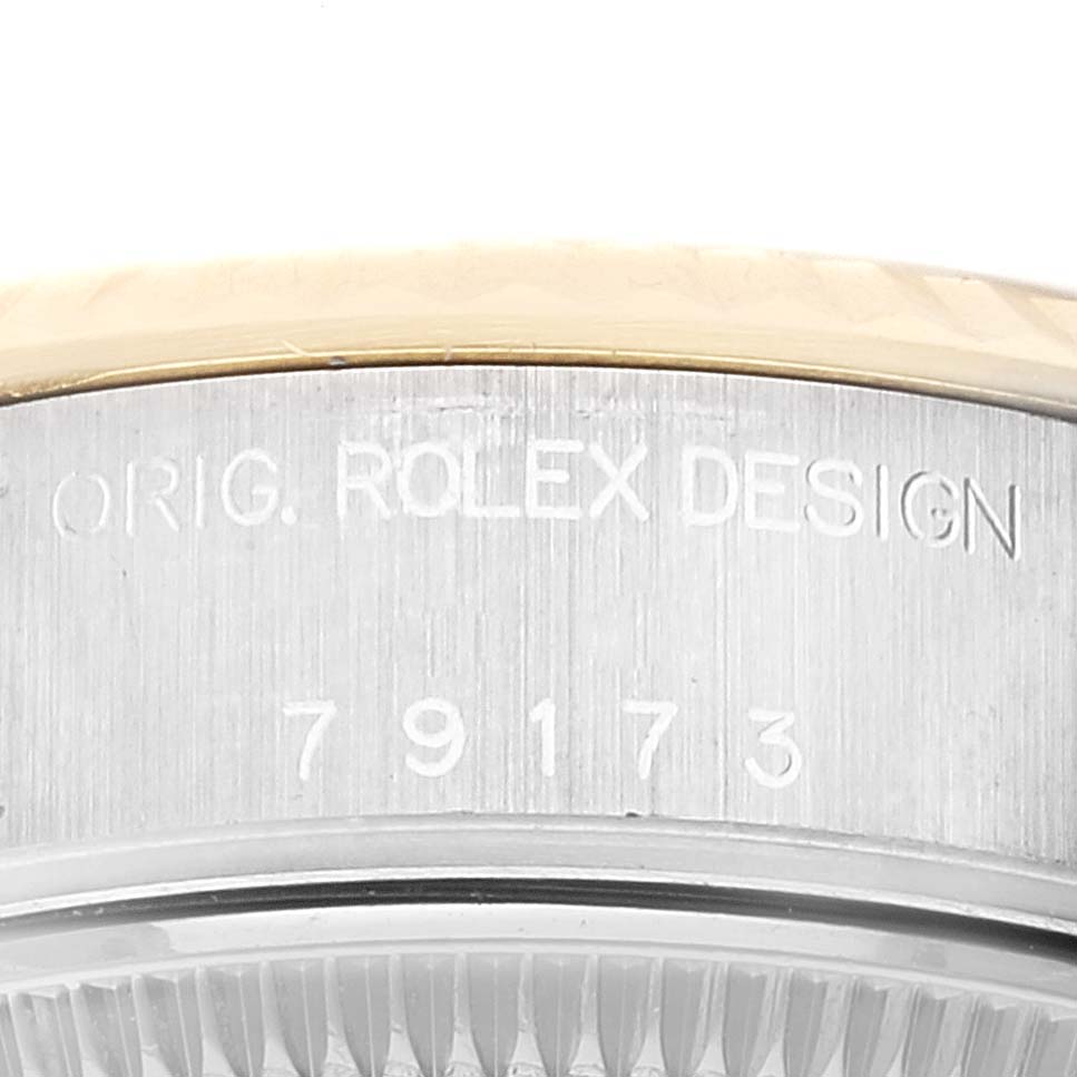 The image shows a close-up view of the case's edge and serial number engraving on a Rolex Datejust 79173 Women's Steel and Gold (two tone) Champagne Dial 79173 Women's Steel and Gold (two tone) Champagne Dial watch.