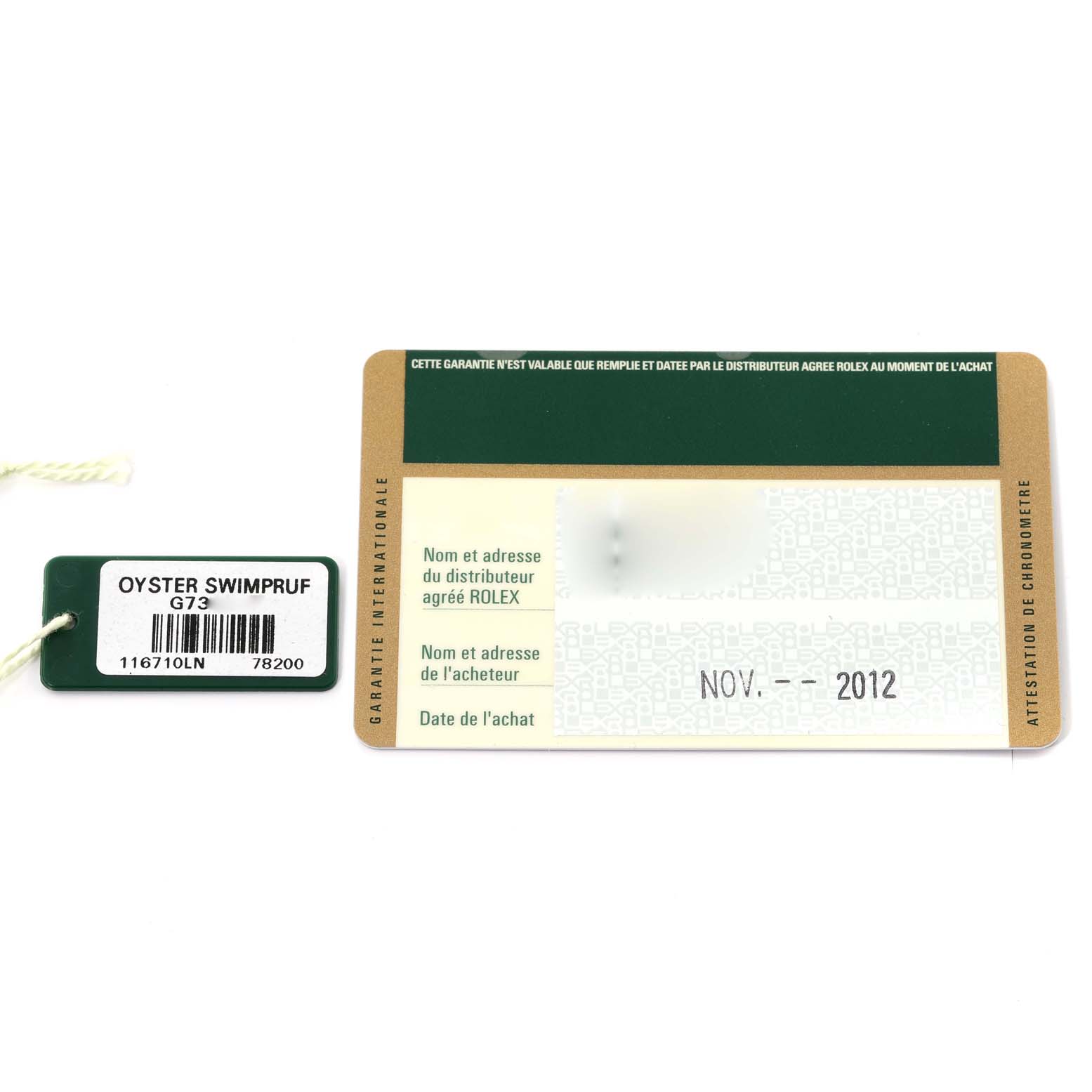 The image shows the warranty card and tag for a Rolex GMT-Master 116710LN Men
s Stainless Steel Black Dial 116710LN Men
s Stainless Steel Black Dial watch from a top-down angle.