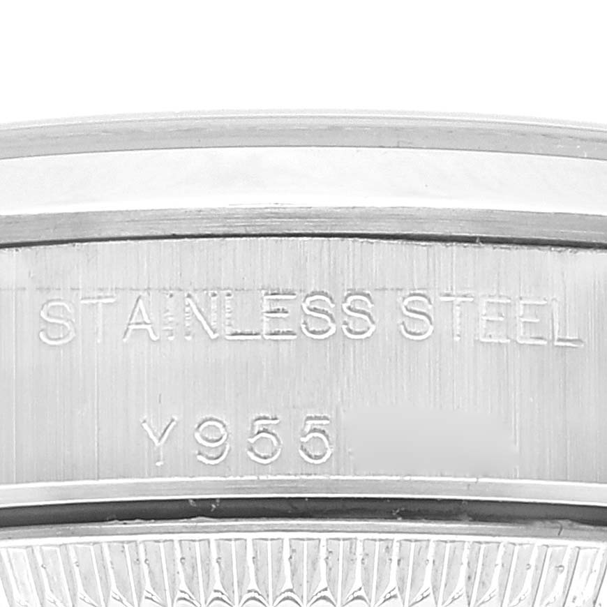 The image shows a close-up of the stainless steel case back of a Rolex Oyster Perpetual 76080 Women's Stainless Steel Black Dial 76080 Women's Stainless Steel Black Dial watch, highlighting the engraved text.
