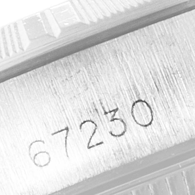 The image shows a close-up of the model number "67230" engraved on the side of a Rolex Oyster Perpetual 67230 Women's Stainless Steel Black Dial 67230 Women's Stainless Steel Black Dial watch.
