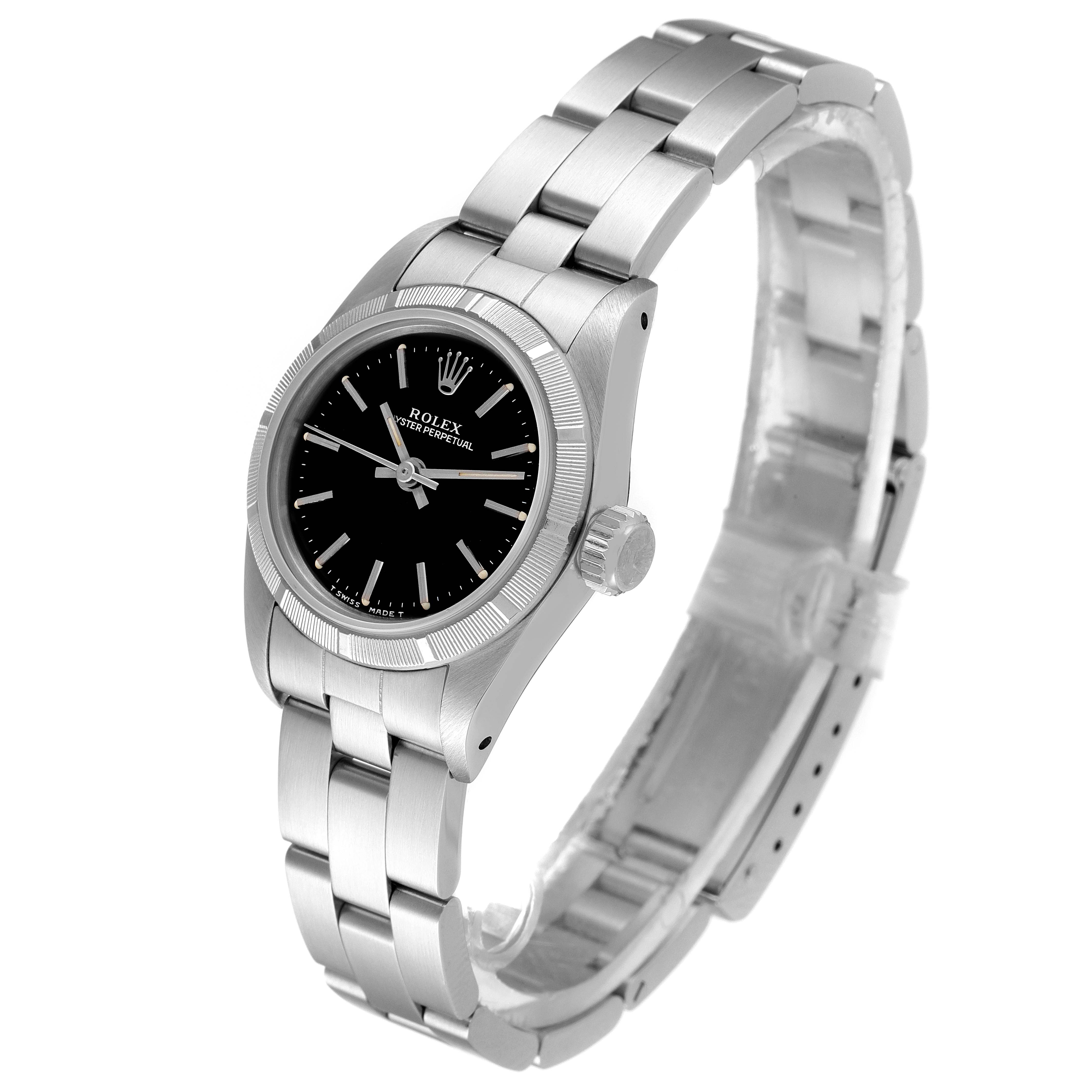 This image shows a Rolex Oyster Perpetual 67230 Women's Stainless Steel Black Dial 67230 Women's Stainless Steel Black Dial watch at a side angle, displaying its face, bezel, crown, and part of the bracelet.