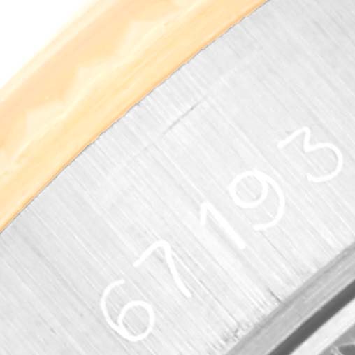 Close-up of the serial number engraved on the case of a Rolex Oyster Perpetual 67193 Women's Steel and Gold (two tone) Champagne Dial 67193 Women's Steel and Gold (two tone) Champagne Dial watch.
