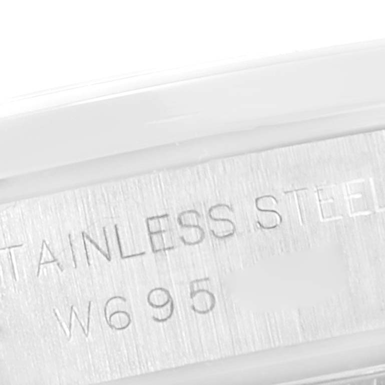 This image shows a close-up of the serial number and "STAINLESS STEEL" engraving inside a Rolex Oyster Perpetual 67180 Women
s Stainless Steel Pink Dial 67180 Women
s Stainless Steel Pink Dial watch case.
