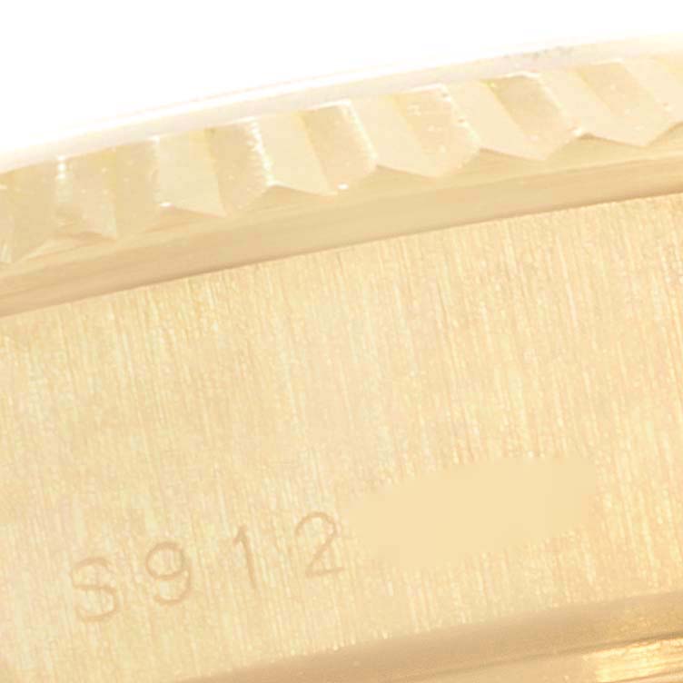 This close-up image shows the side view of a Rolex President 69178 Women
s Yellow Gold Champagne Dial 69178 Women
s Yellow Gold Champagne Dial model, focusing on the edge and engraved serial number on its case.