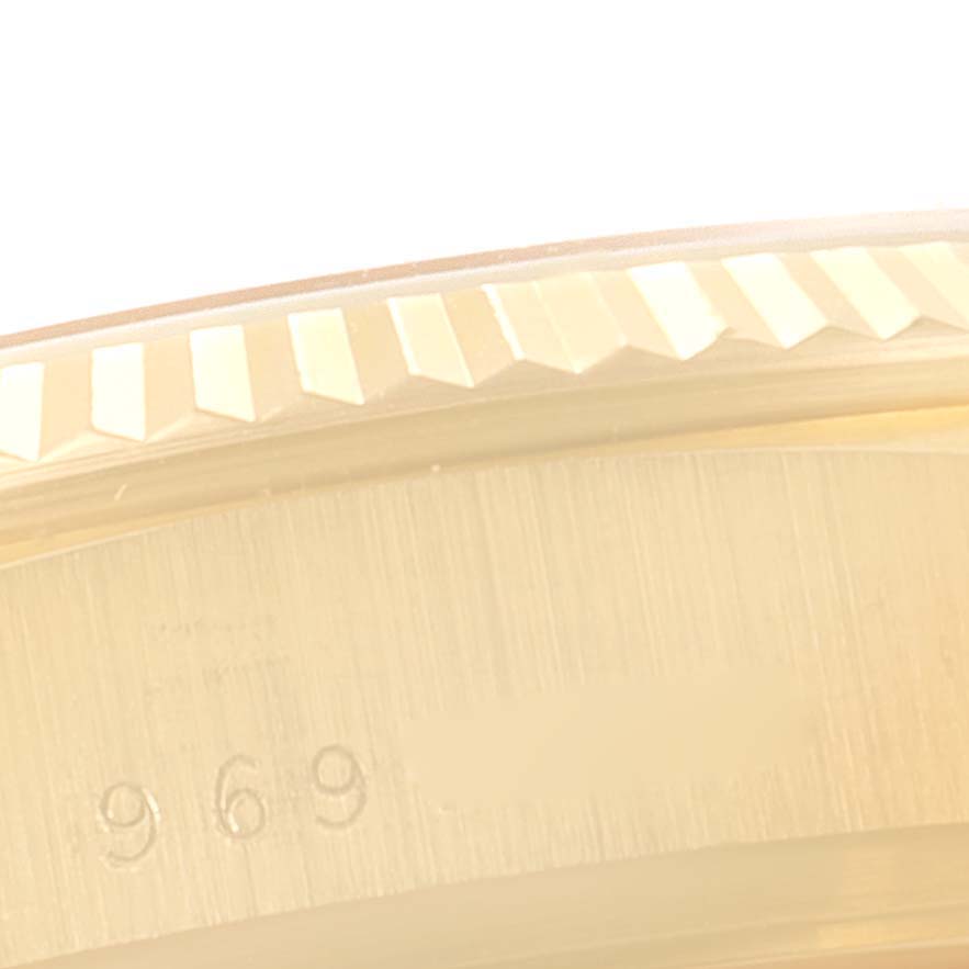 This close-up image shows the fluted bezel and engraved serial number of a Rolex President 18038 Men
s Yellow Gold Champagne Dial 18038 Men
s Yellow Gold Champagne Dial model watch.