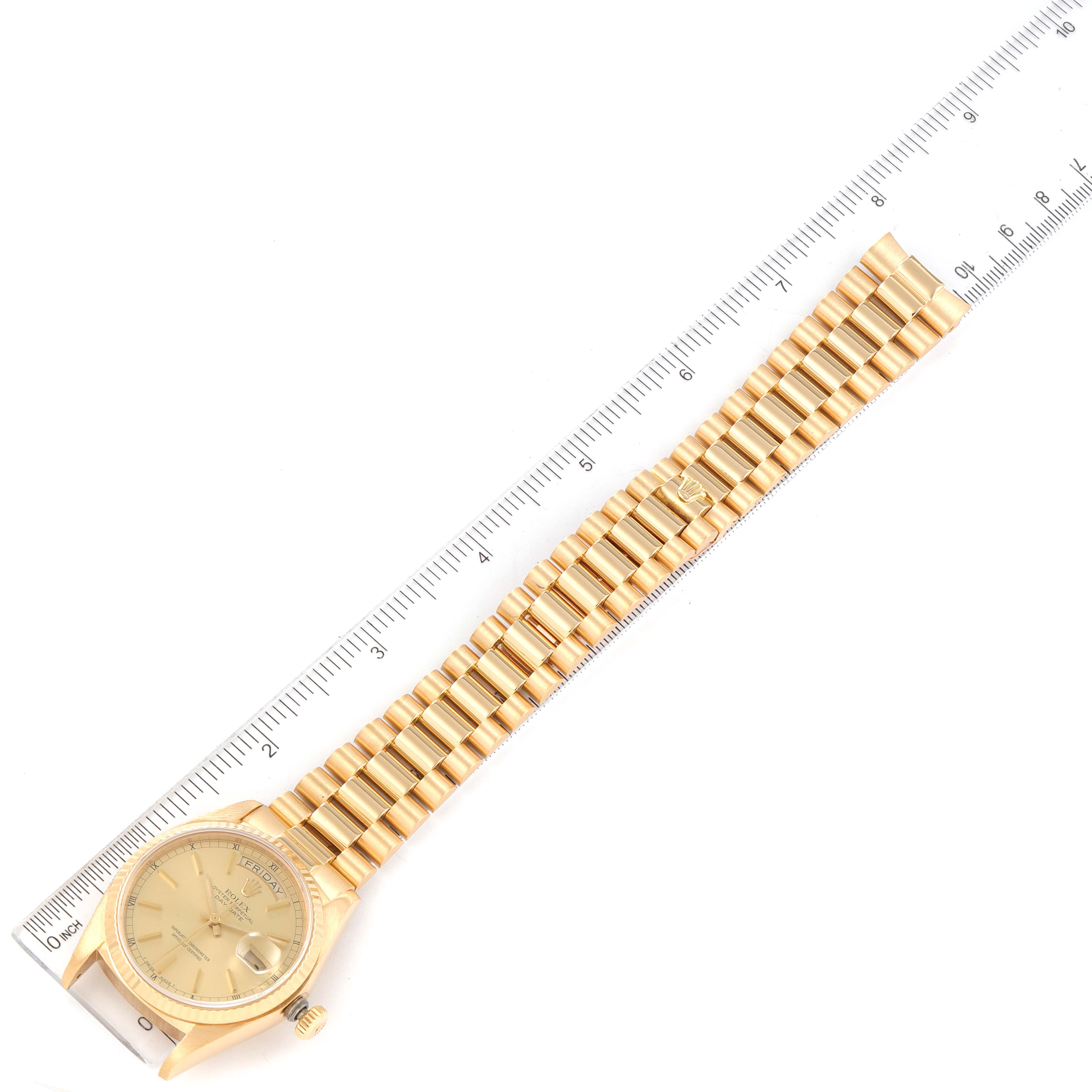 The image shows a Rolex President 18038 Men's Yellow Gold Champagne Dial 18038 Men's Yellow Gold Champagne Dial model watch laid flat with its bracelet fully extended next to a ruler for size reference.
