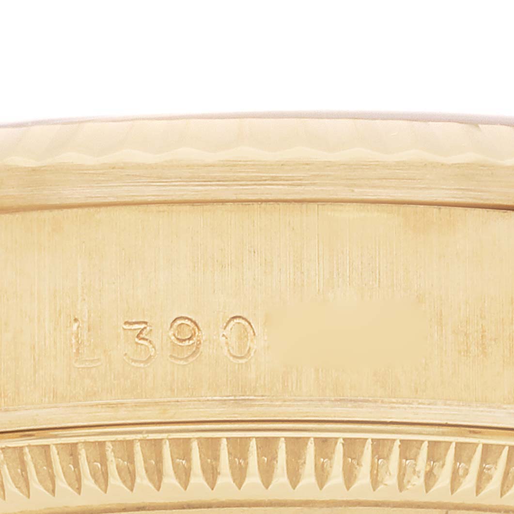 This close-up image shows the serial number engraved on the case of a Rolex President 68278G Women's Yellow Gold Black Dial 68278G Women's Yellow Gold Black Dial model watch.